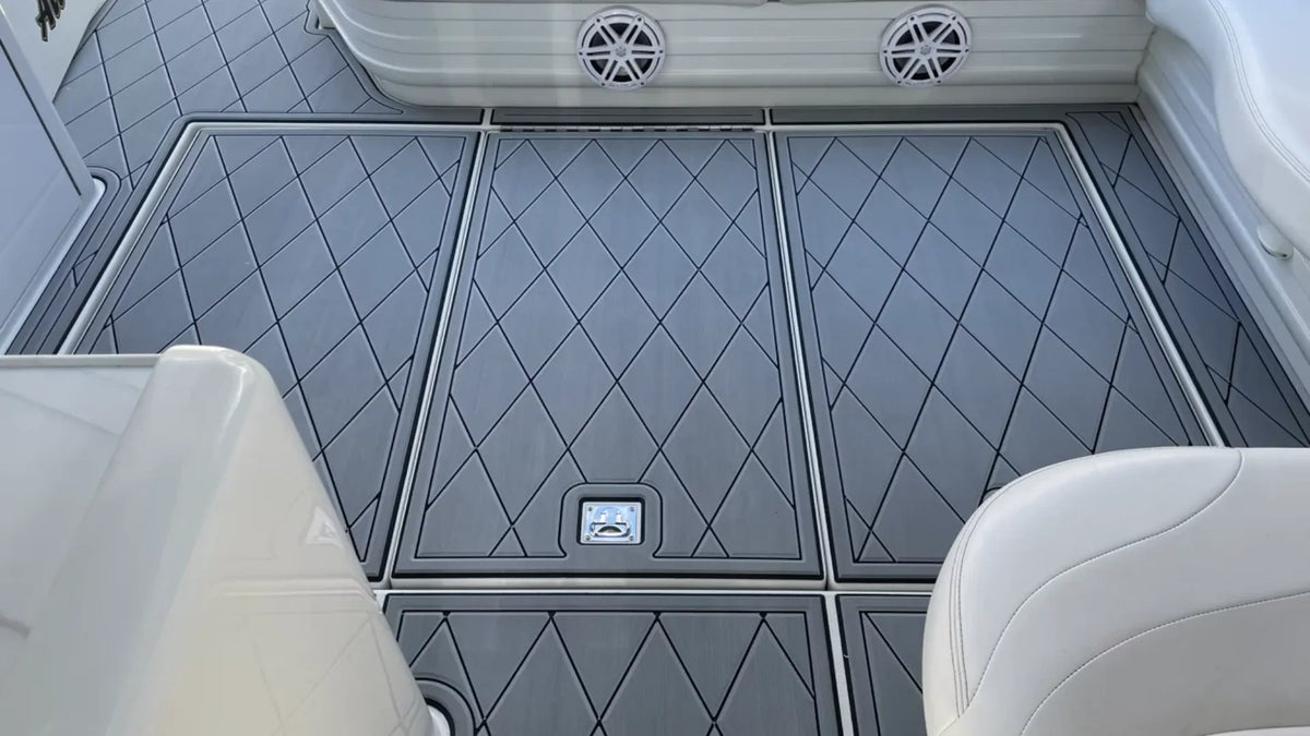 Grey diamond-pattern boat flooring panels with dark borders, aligned seams and separate access hatches