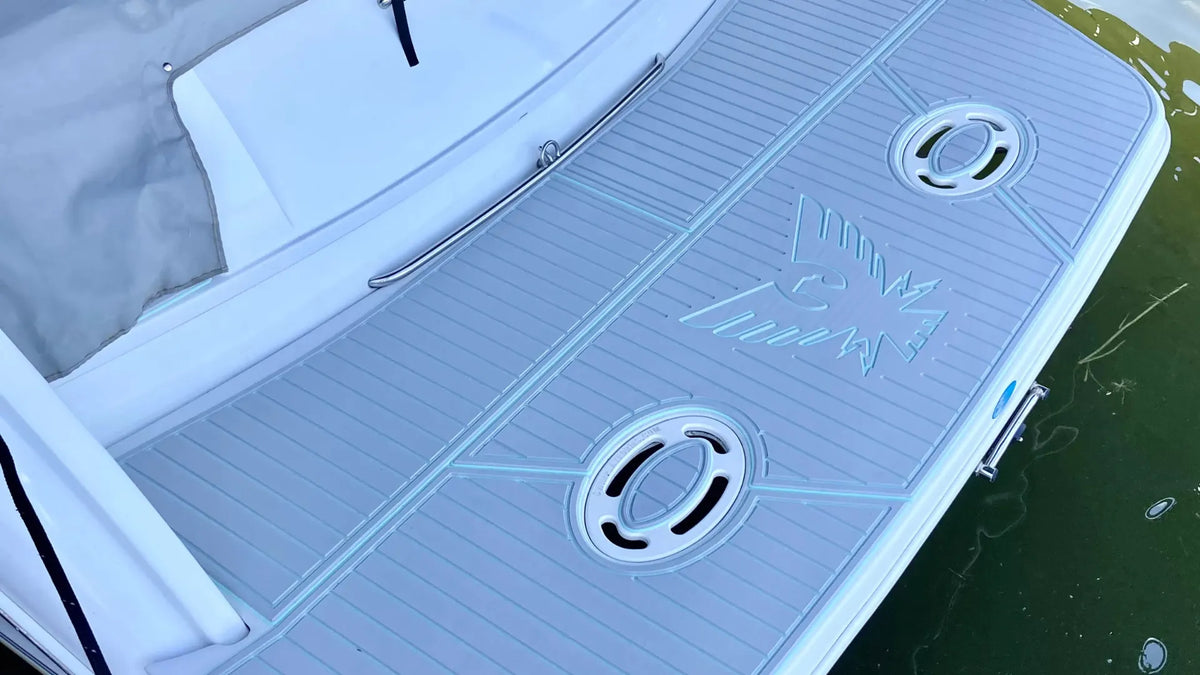 Light grey grooved boat deck pad with dark edging and circular fittings, showing surface color and pattern