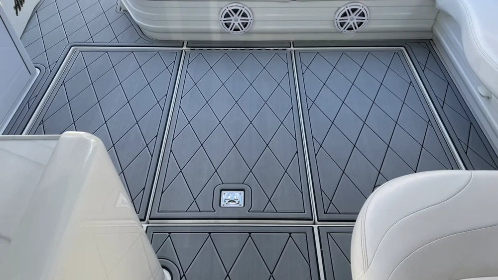 Grey diamond-pattern boat flooring panels with dark borders, aligned seams and separate access hatches
